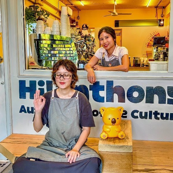 Baristas at Hi Anthony Cafe in Bangkok, smiling and welcoming guests in a warm, Aussie-style coffee space.